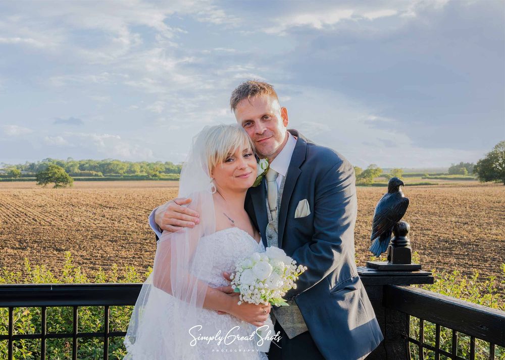 Winters Tale Country Barn Wedding Photographer captures the Bride and Groom in a posed shot on the Ember Eve Barn balcony during sunset