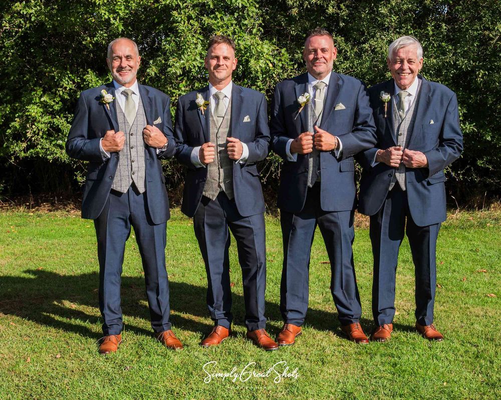 A posed shot of the Groom, Best Man, Fathers of the Bride & Groom in the gardens on Winters Tale Country Barn, by a Wedding Photographer