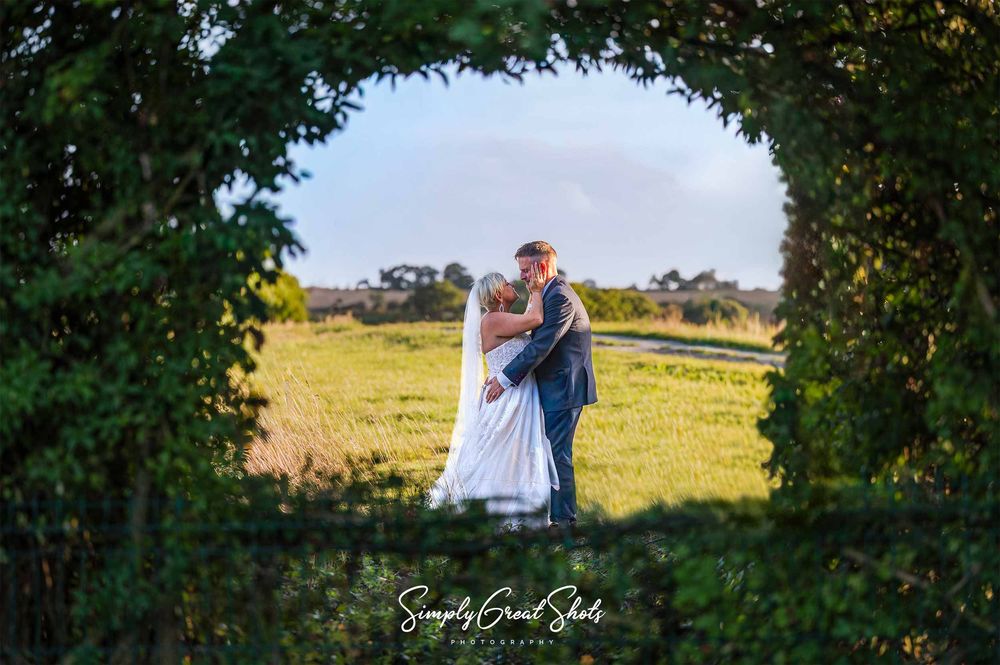 A Winters Tale Country Barn Wedding Photographer captures the Bride and Groom sharing an intimate moment from the secret garden.