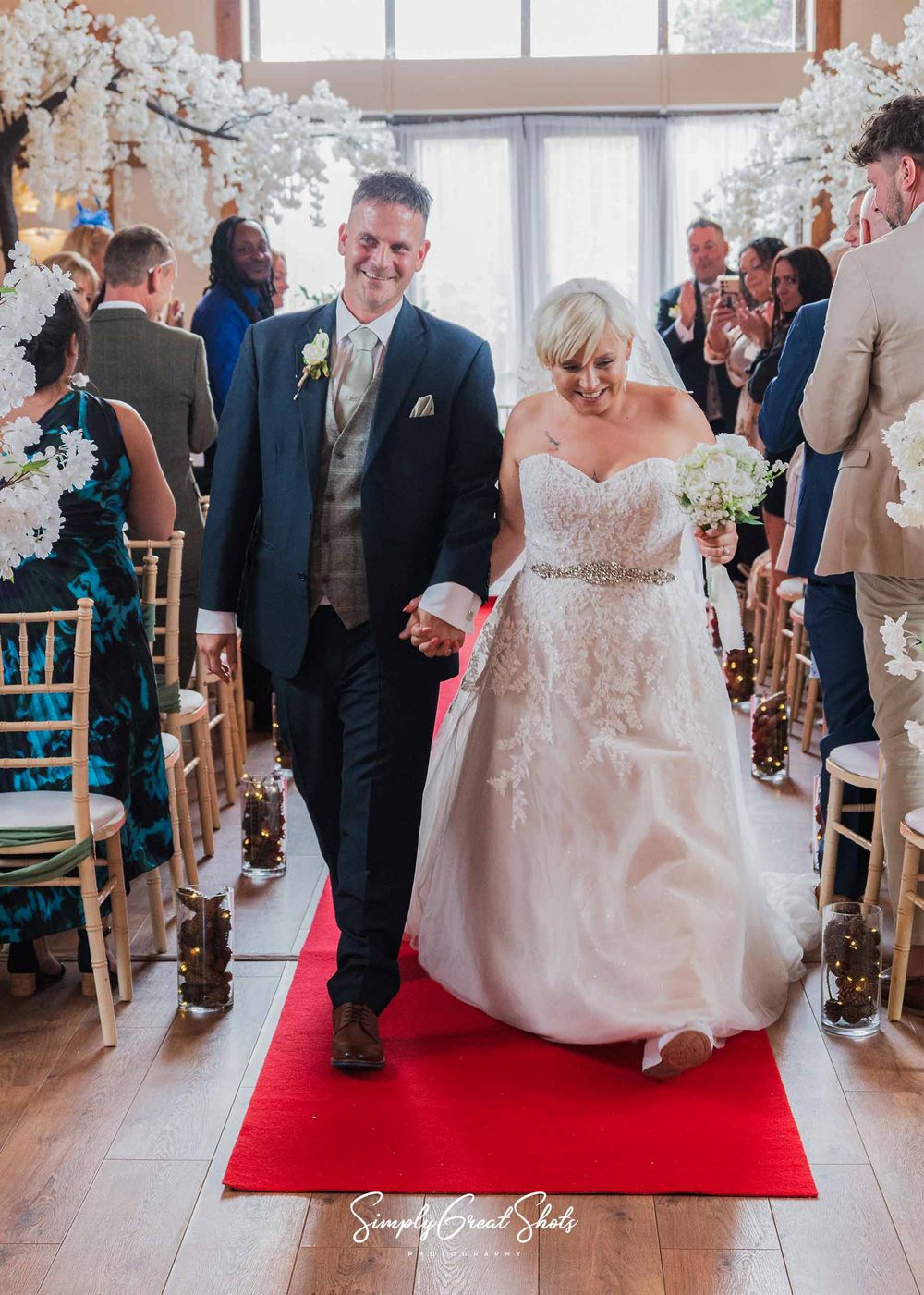 Winters Tale Country Barn wedding photographer captures the Bride (Faye), and the groom (Craig) walking down the aisle as Husband and Wife