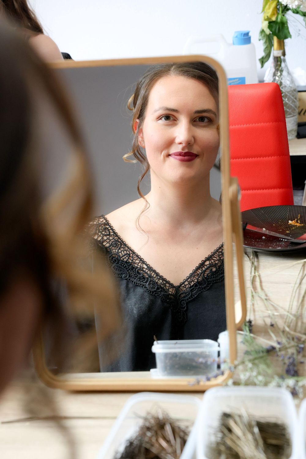 A person wearing a black top with sparkly details is shown in a series of cropped portrait shots.