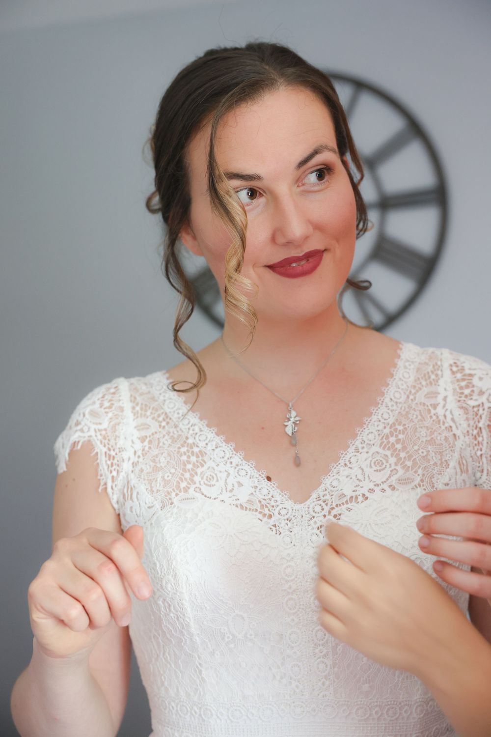 A sequence of photos showing someone in a white lace wedding dress getting ready and making hand gestures.