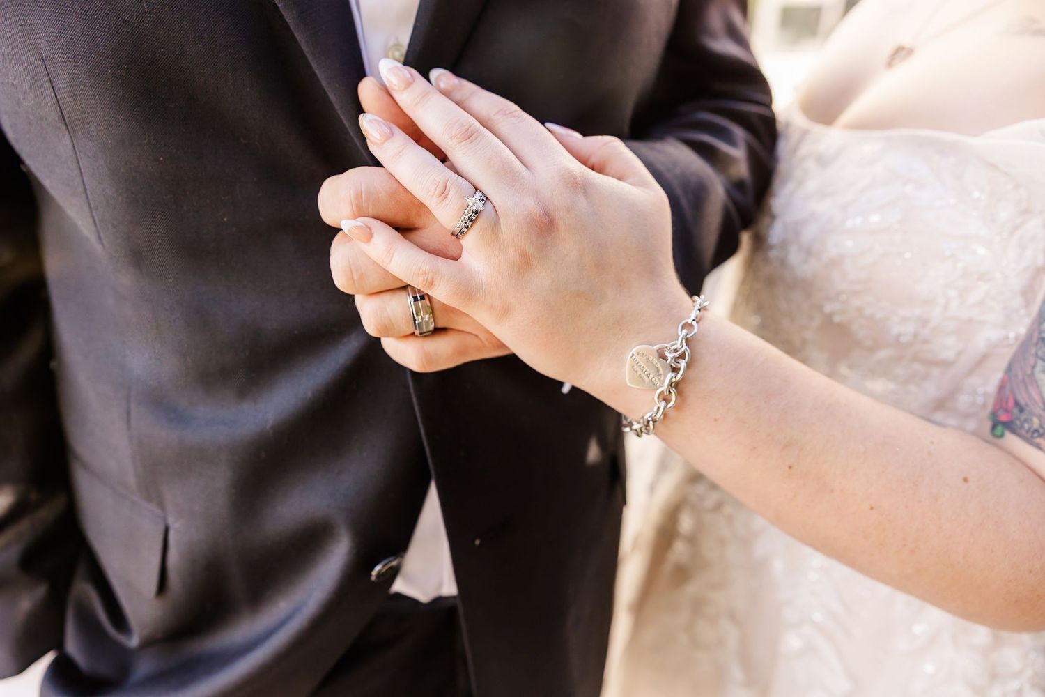 Close-up shot of hands exchanging wedding rings during a marriage ceremony.