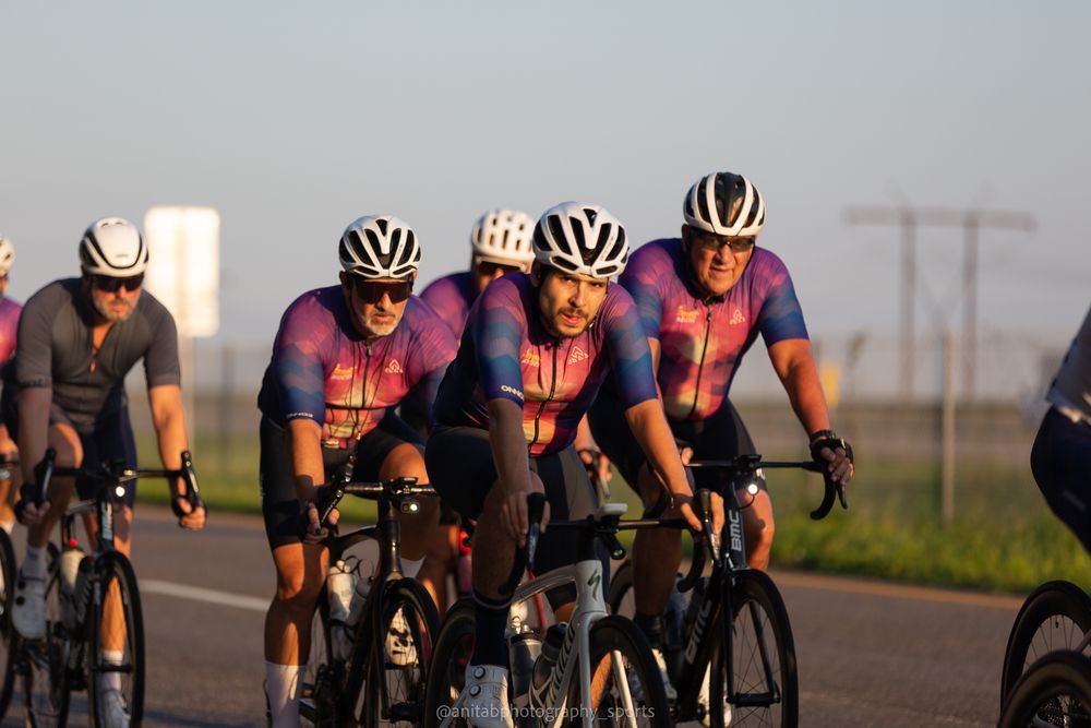 Professional cycling team riding in tight formation during an evening training session.
Sports photography.