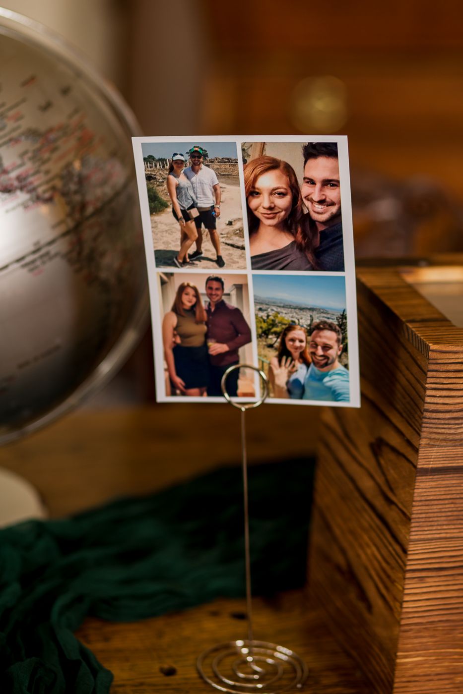 A collection of personal photos displayed on a wire holder with a globe in the background.
