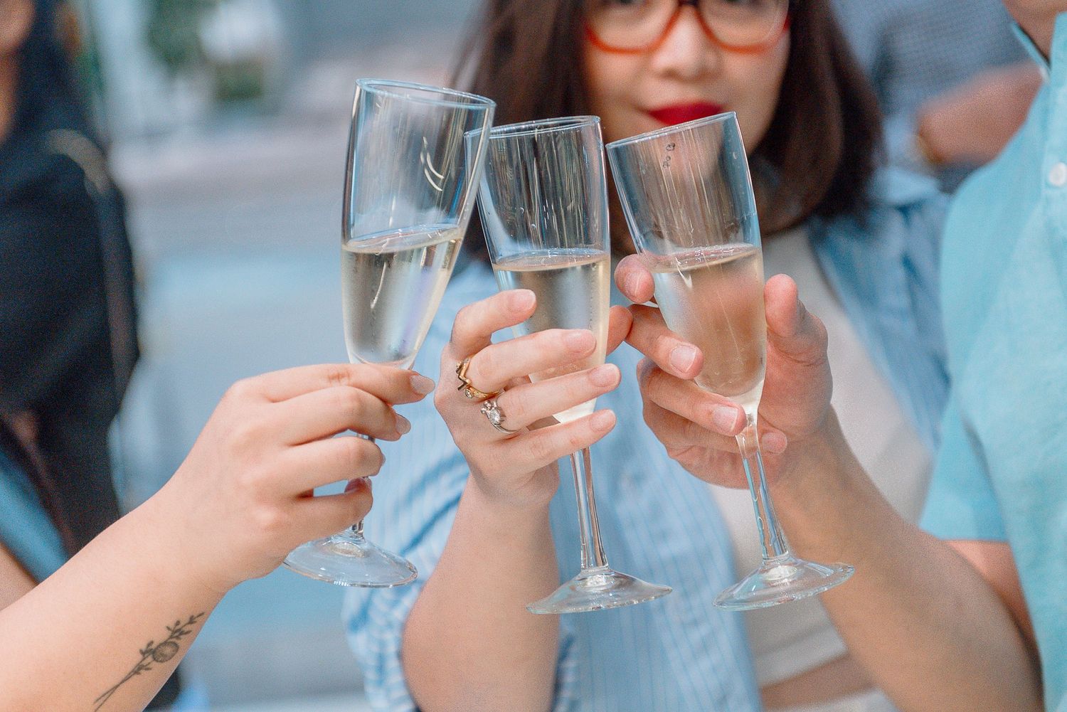 A group of people toasting with wine glasses during a celebration event.