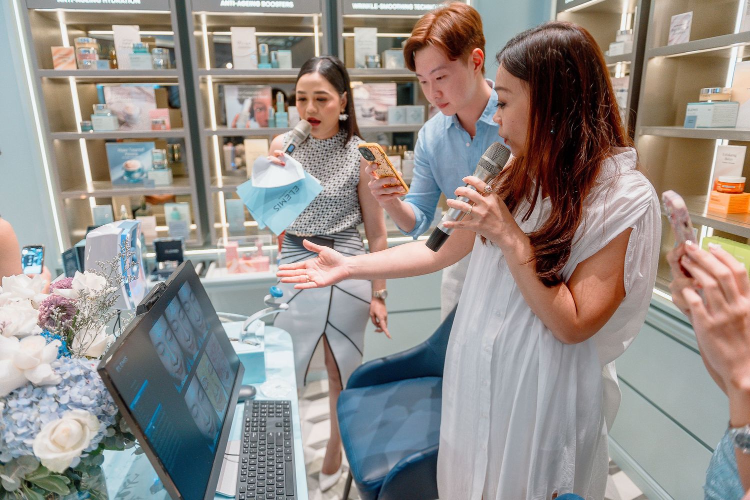 Healthcare team collaborates while looking at a laptop display in a medical supply storage room.
