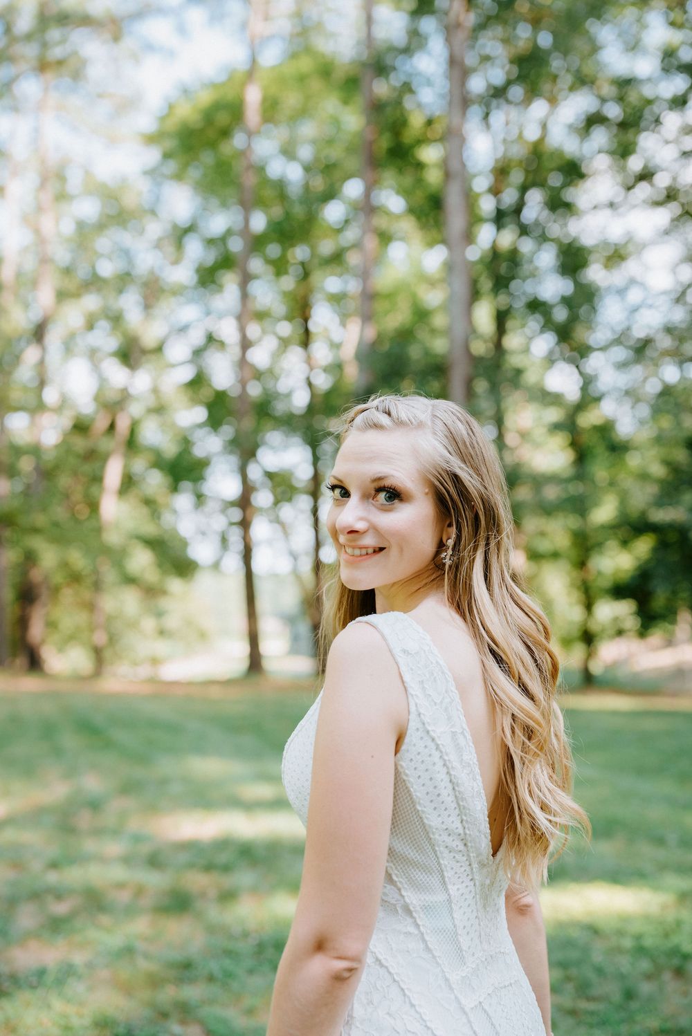 A series of portrait shots showing a person in a white lace dress standing in a sunlit outdoor garden setting.