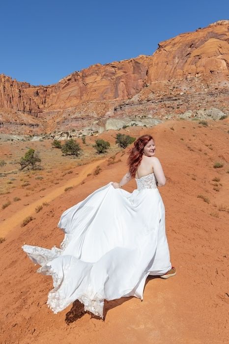 A flowing white dress contrasts dramatically against red desert rocks and blue sky in a series of artistic photos.