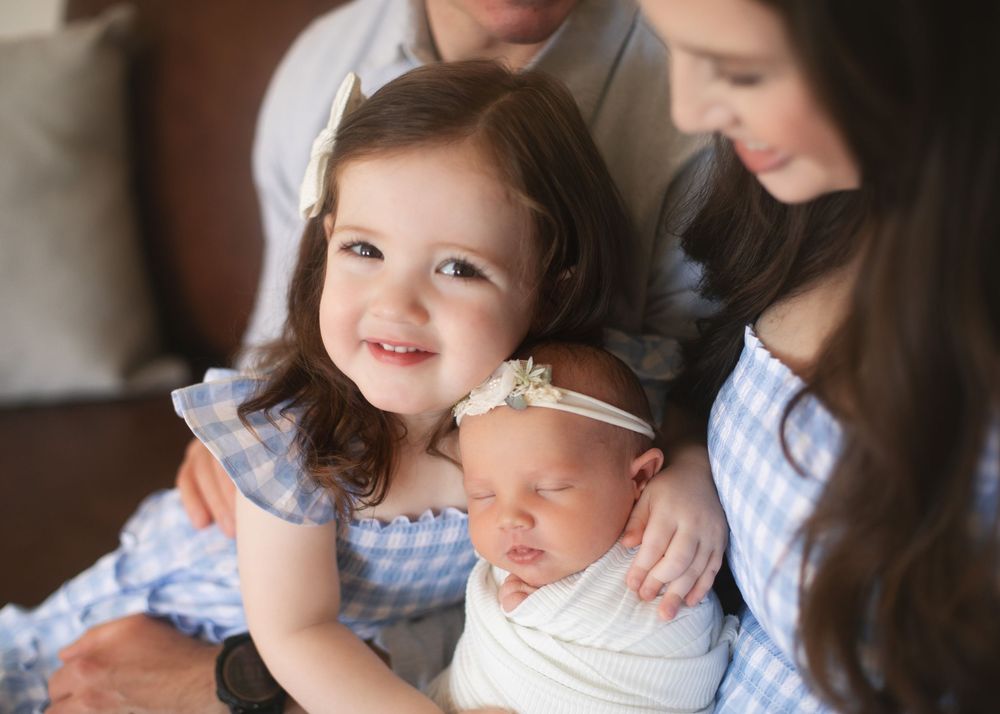 Indoor family portrait series showing tender moments between siblings.