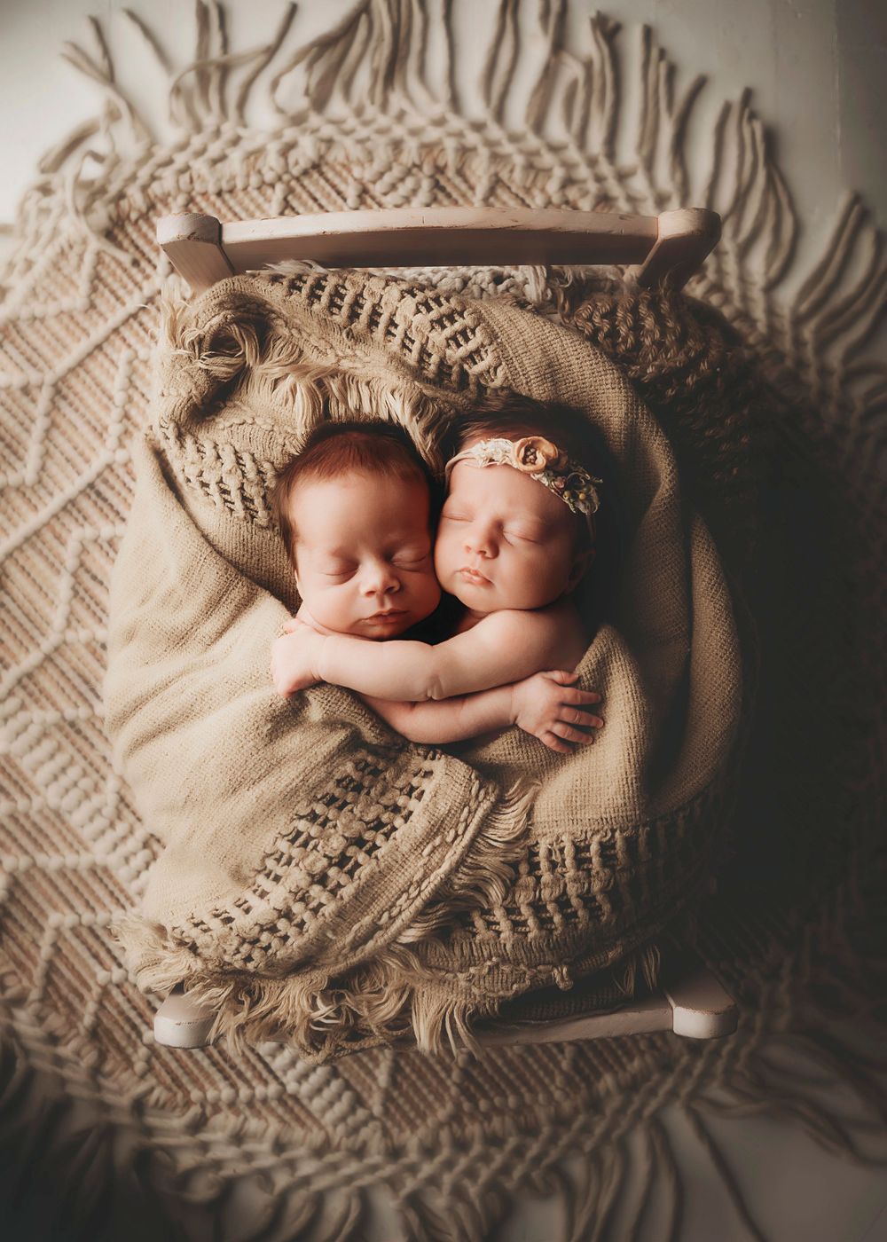 Newborn photography series on knitted blanket in warm sepia tones.