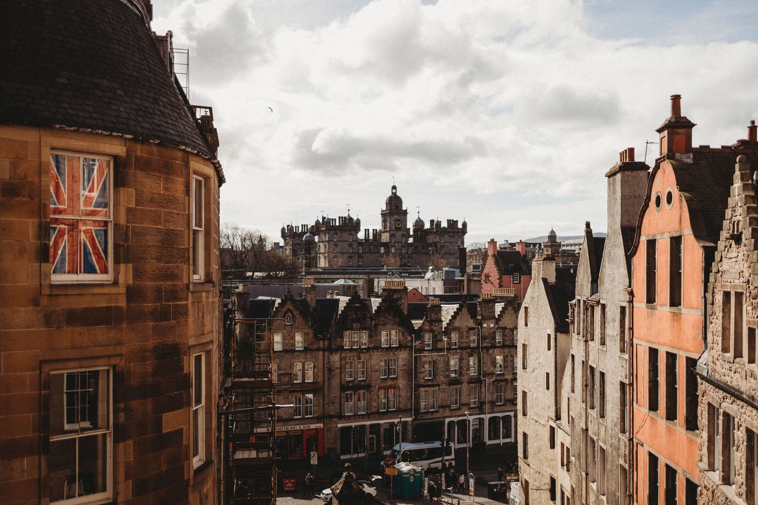 Historic buildings and architecture along Victoria Street in Edinburgh's Old Town on a cloudy day.