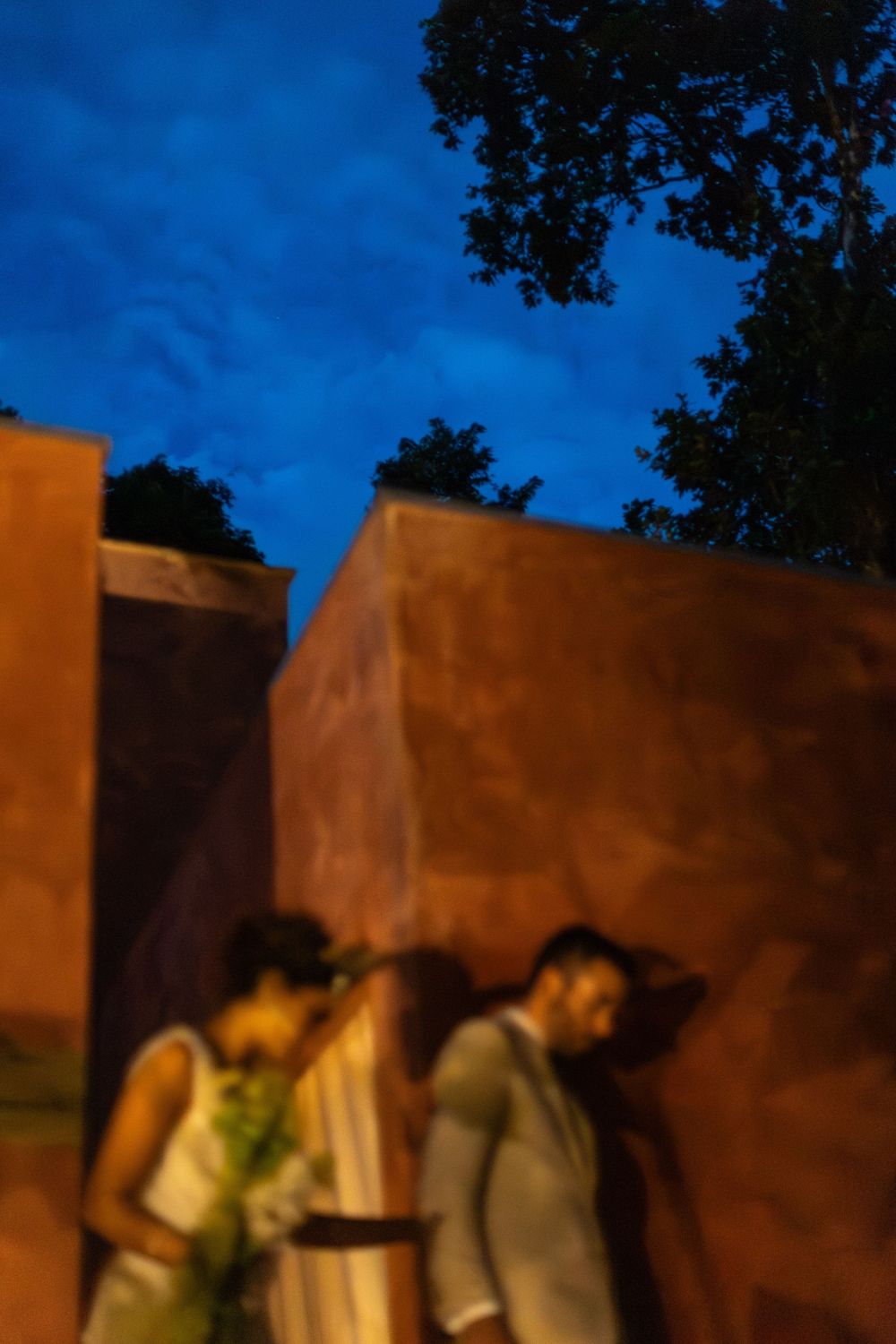 A series of five connected images showing a brown adobe wall against a deep blue sky at dusk.