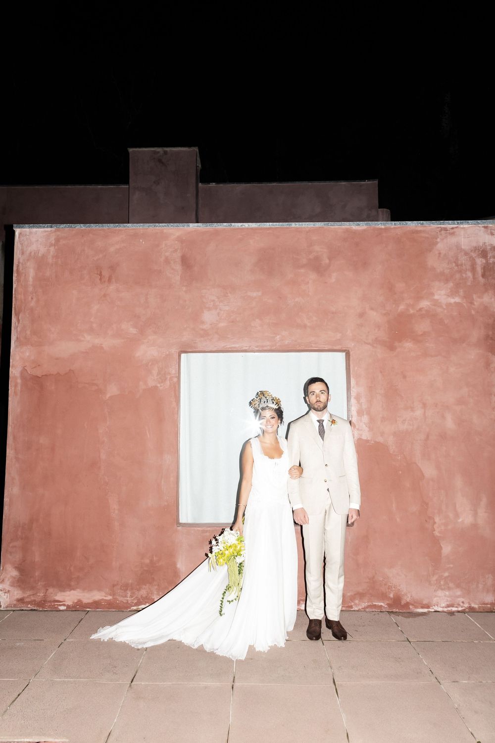 A sequence of four photos showing a bride and groom's shadows cast on a pink wall at different angles and poses.
