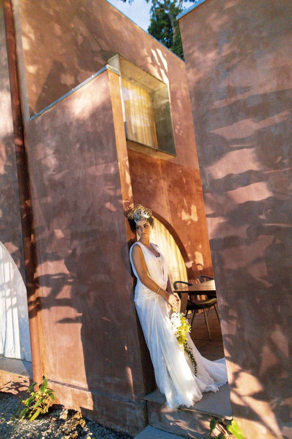A series of artistic photos showing a white dress against a textured pink wall with dappled sunlight.