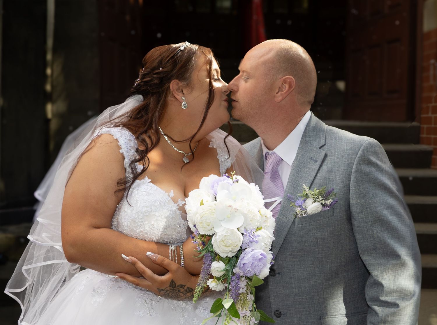 A series of romantic wedding photos showing tender moments between a bride and groom with white and purple floral bouquets.