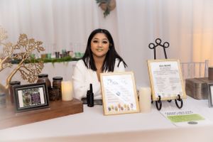 Event display table with framed photos, decorative stands, and business materials.