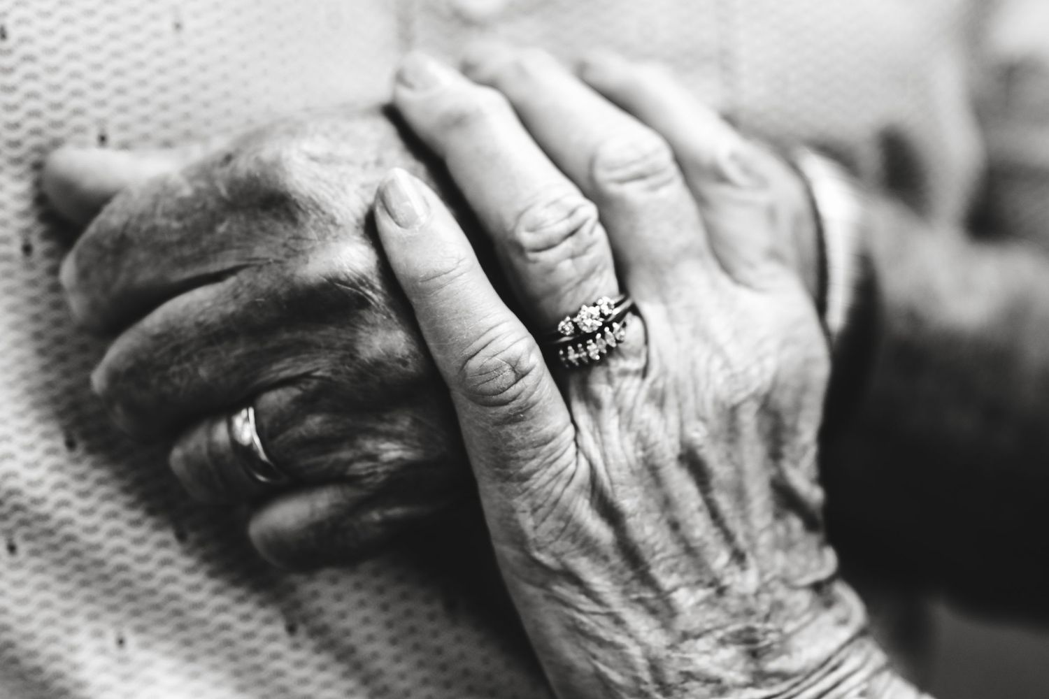 Husband and wife's hands on 50th anniversary.