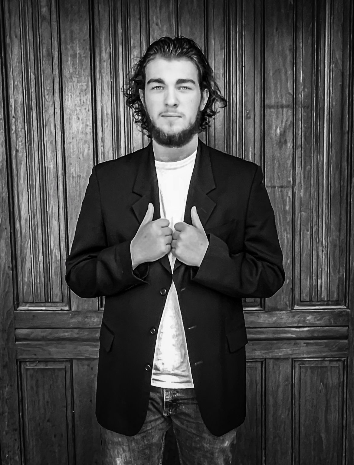 Young man holding suit jacket in Lafayette, Indiana.