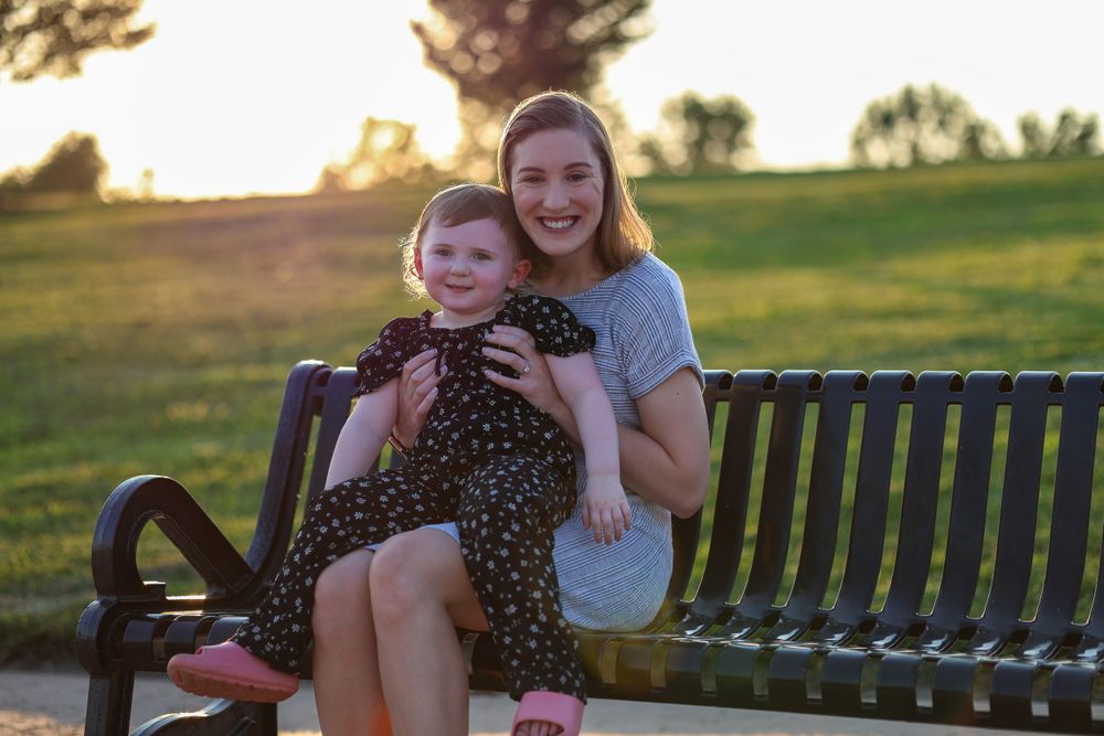 A sweet moment shared on a park bench at sunset.