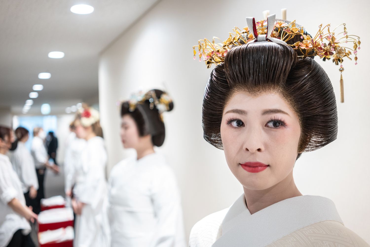 Traditional Japanese bride in white kimono and ornate headdress.