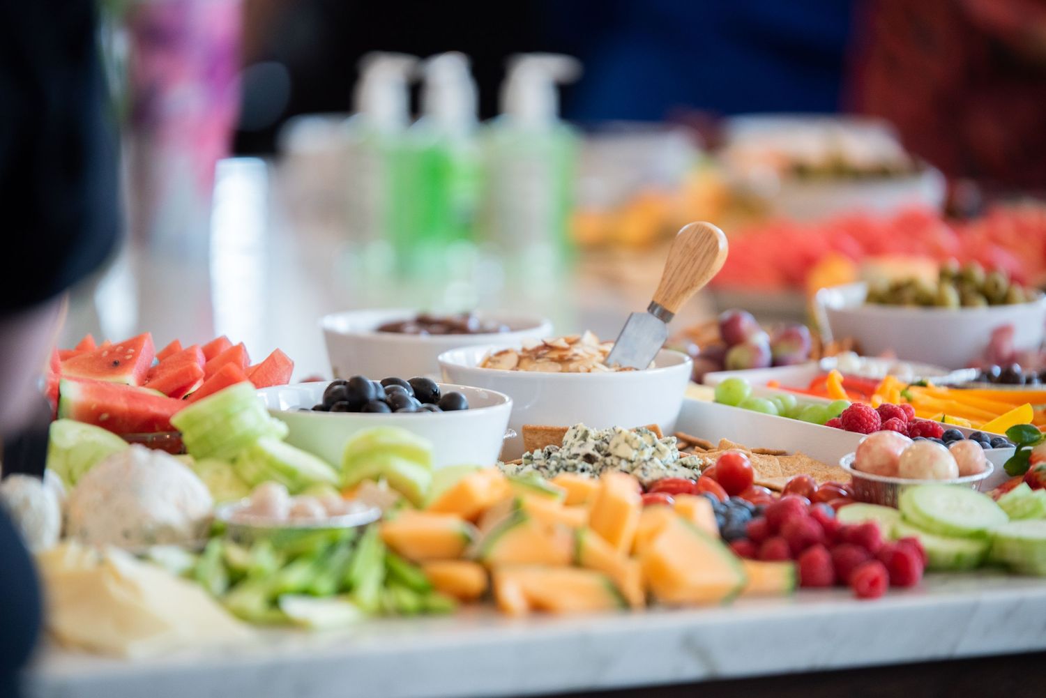 Colorful catering platter with fresh fruits, vegetables and assorted appetizers.