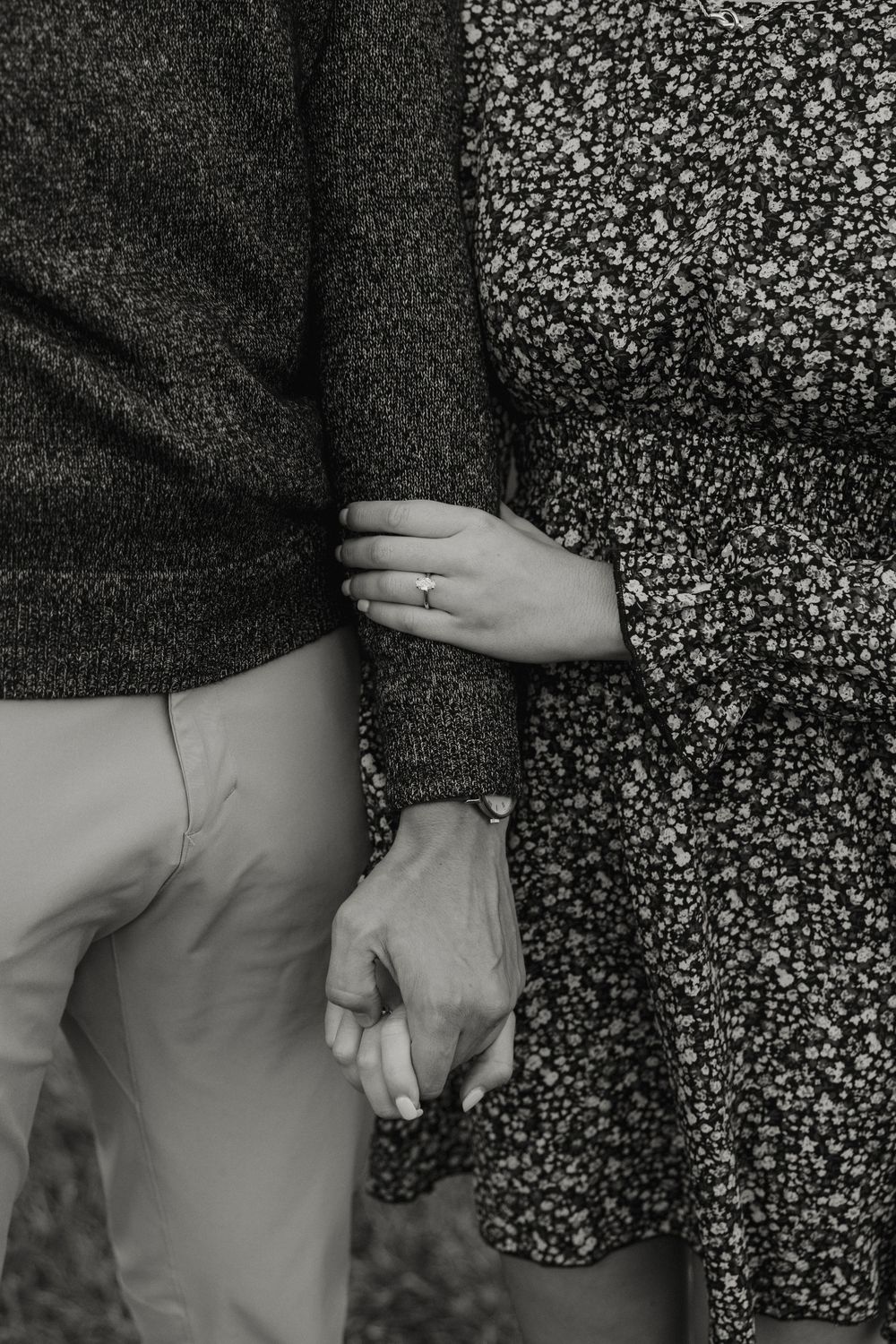 Black and white photo series showing two hands gently clasping together against a floral patterned background.