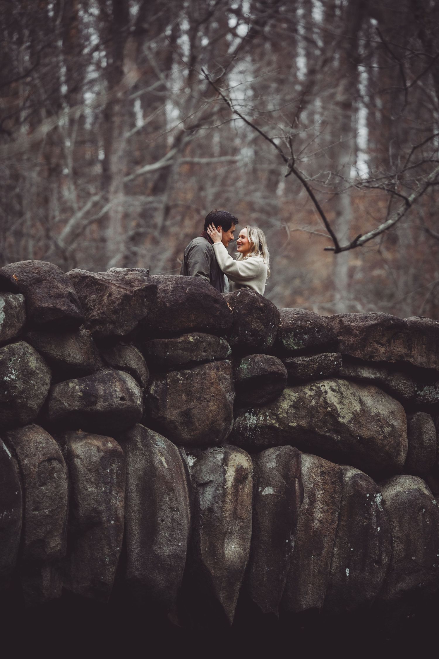 Joyful married couple shares loving moment outdoors with their dogs at the rock creek park