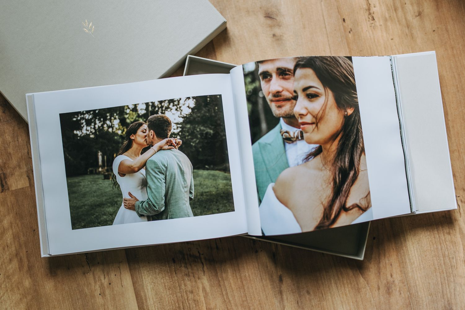 Multiple photo prints are arranged in a line on a wooden surface showing a collection of memories.