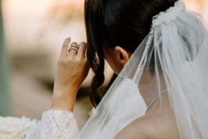Close-up of emotional wedding ceremony moment with delicate veil details.
