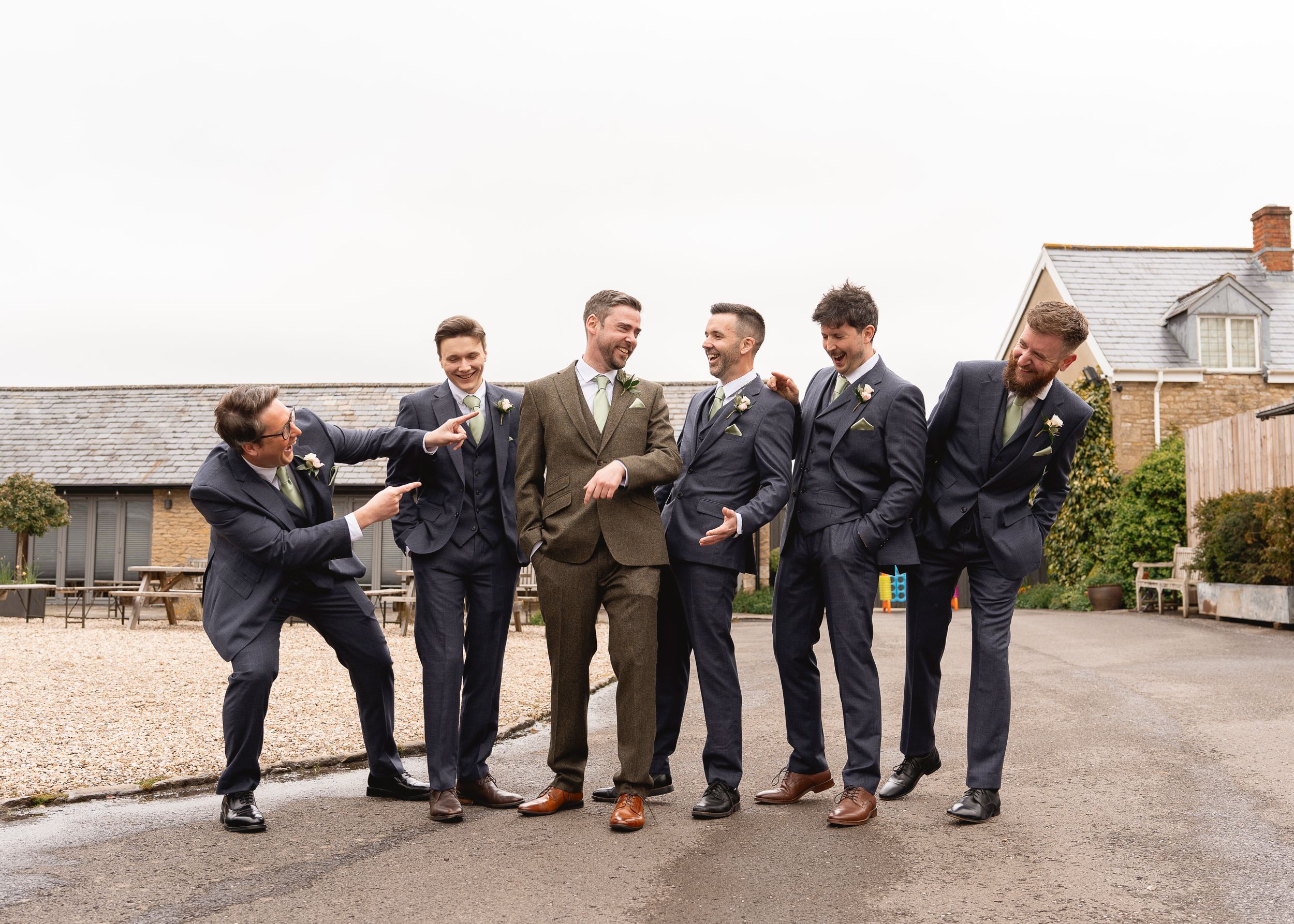 Groomsmen strike playful poses in a fun photo sequence against stone walls.