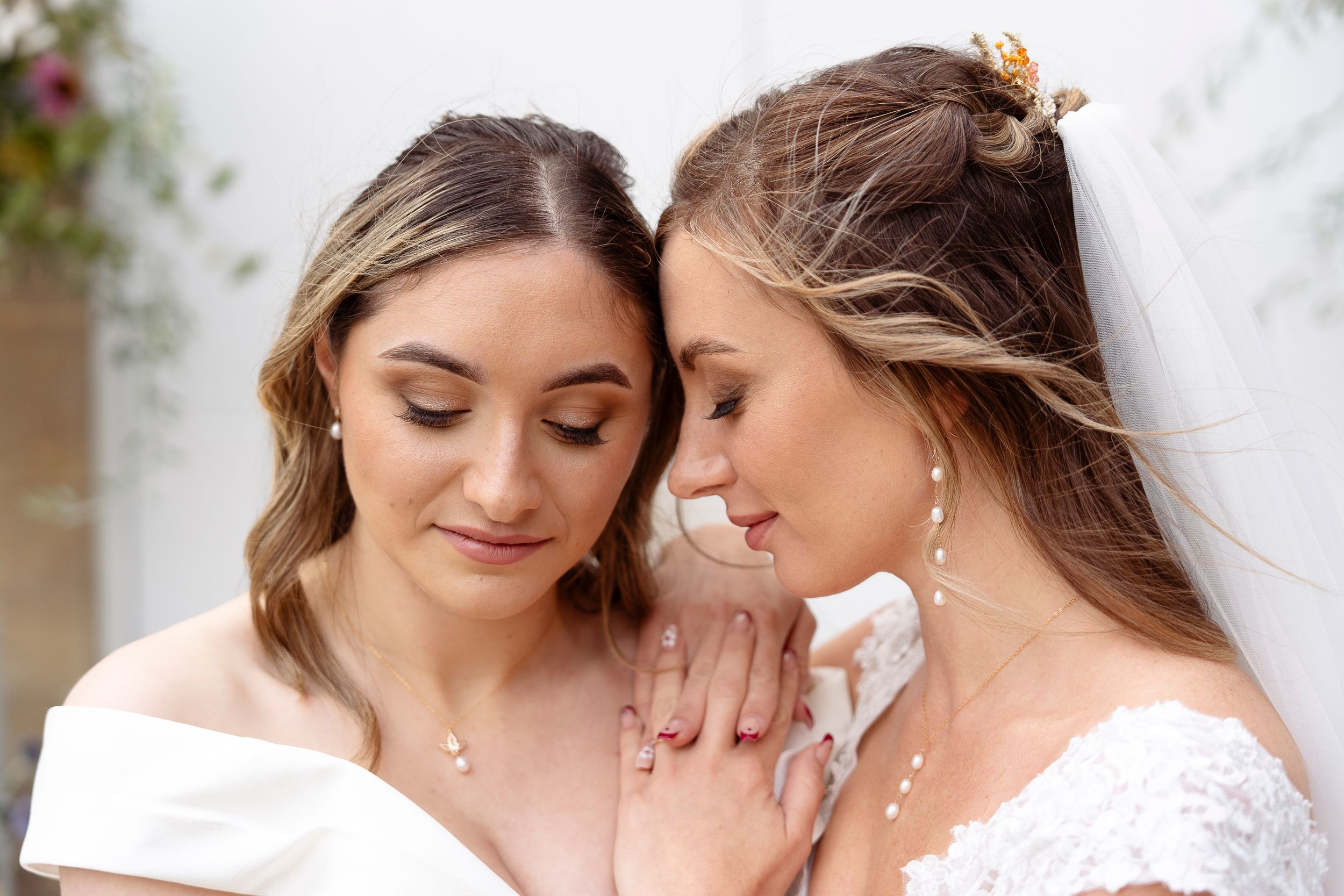 Intimate wedding portrait with soft natural lighting and delicate romantic styling.