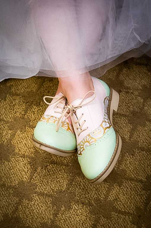 Mint green and cream saddle oxford shoes with lace-up detail, worn with a white tulle skirt.