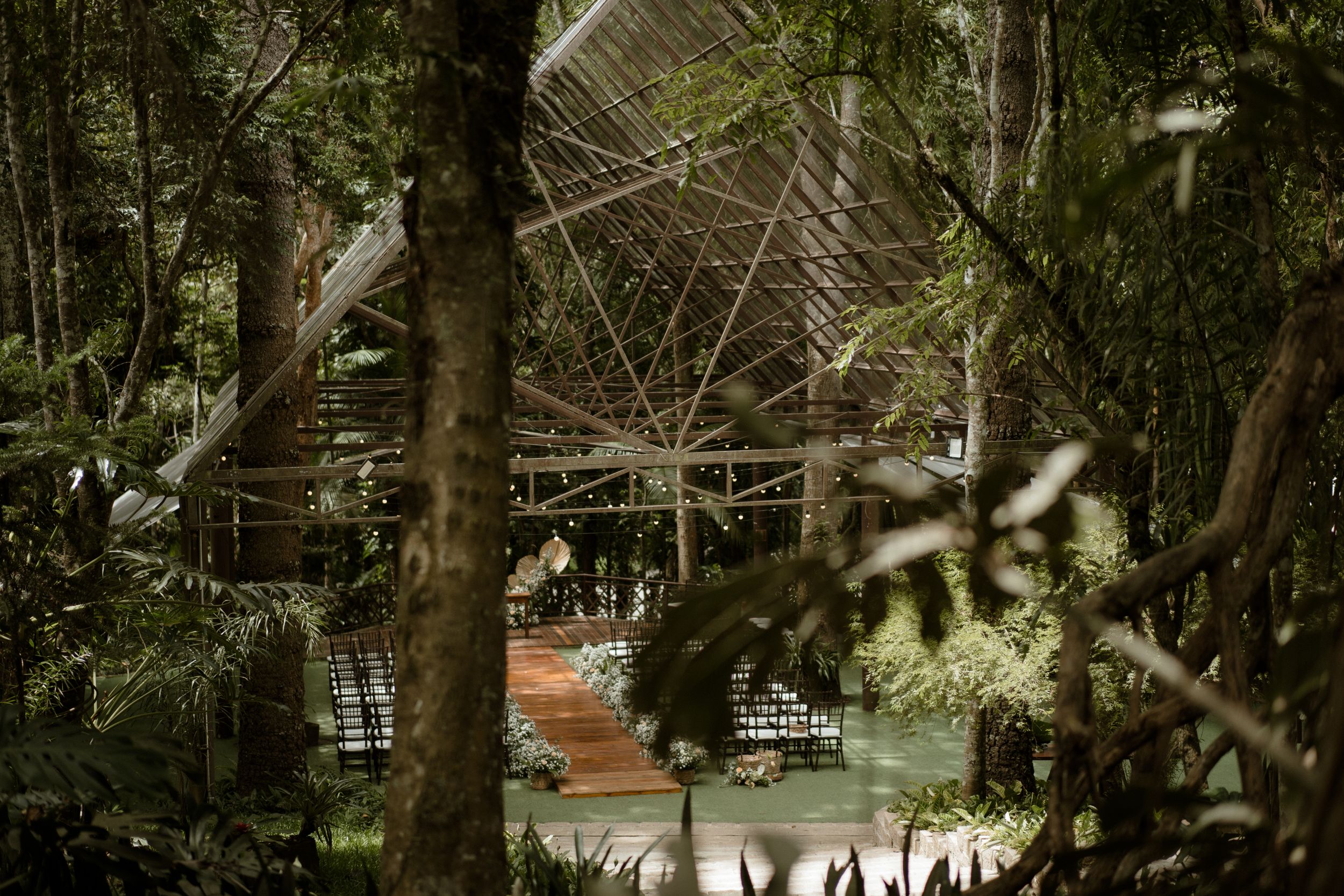 Ethereal garden wedding venue with natural light filtering through trees.