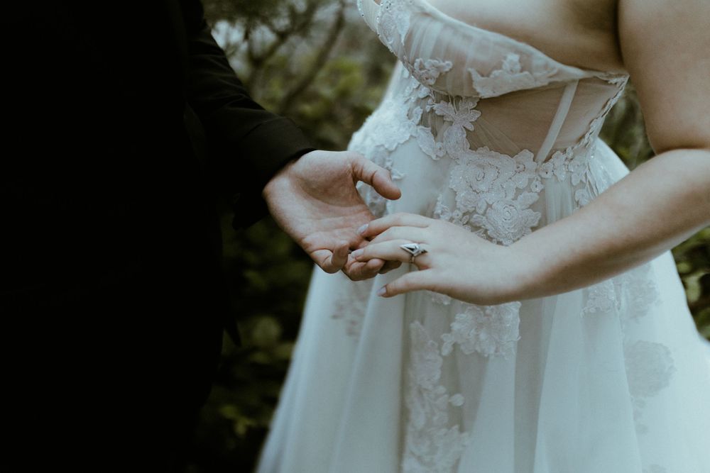 Detail shot of an elegant white lace wedding dress bodice.