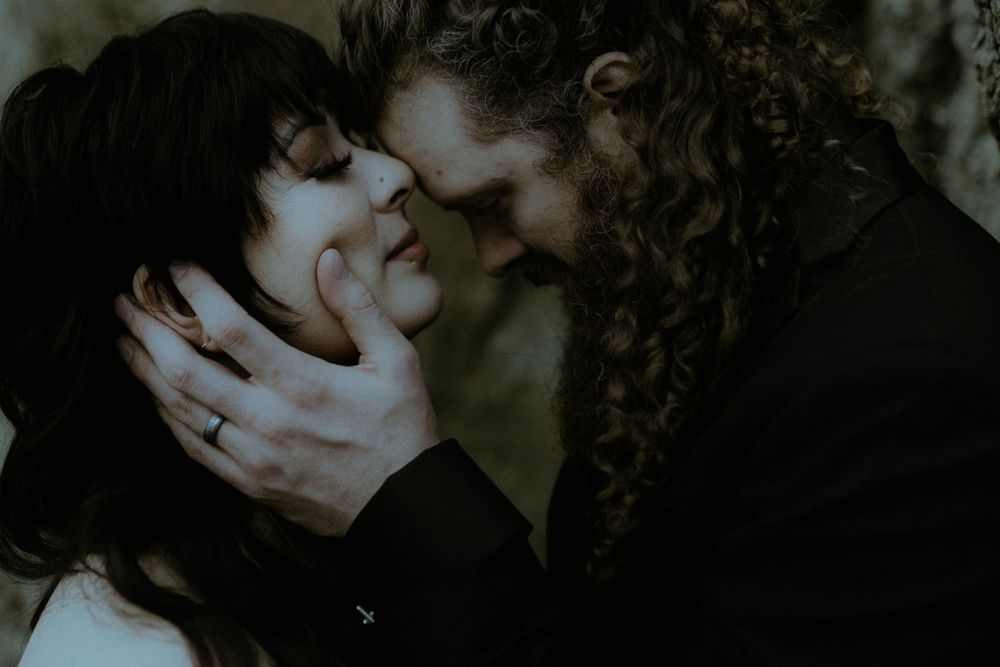 Intimate dark toned portrait with romantic atmospheric lighting.