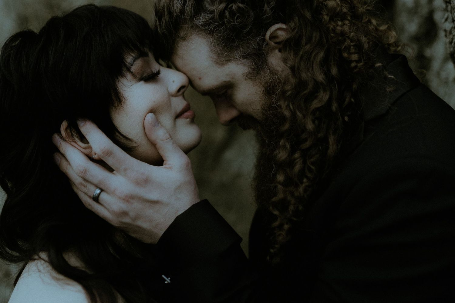 Intimate dark toned portrait with romantic atmospheric lighting.