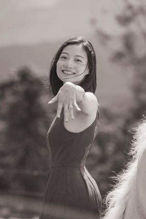 A joyful moment captured in black and white against a mountain landscape.