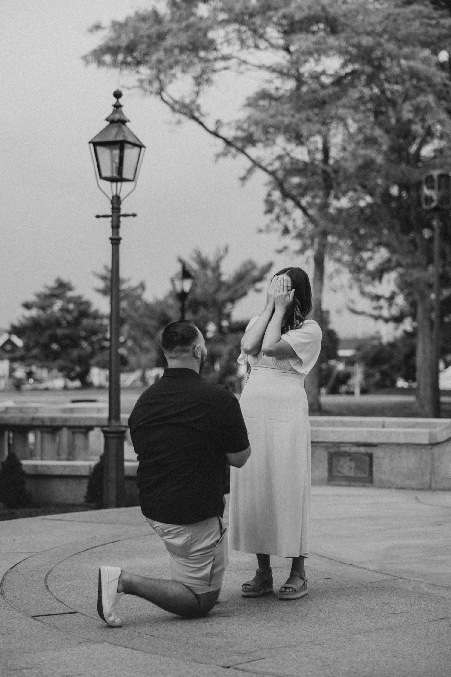 A joyful couple celebrating while walking down a sandy path together.