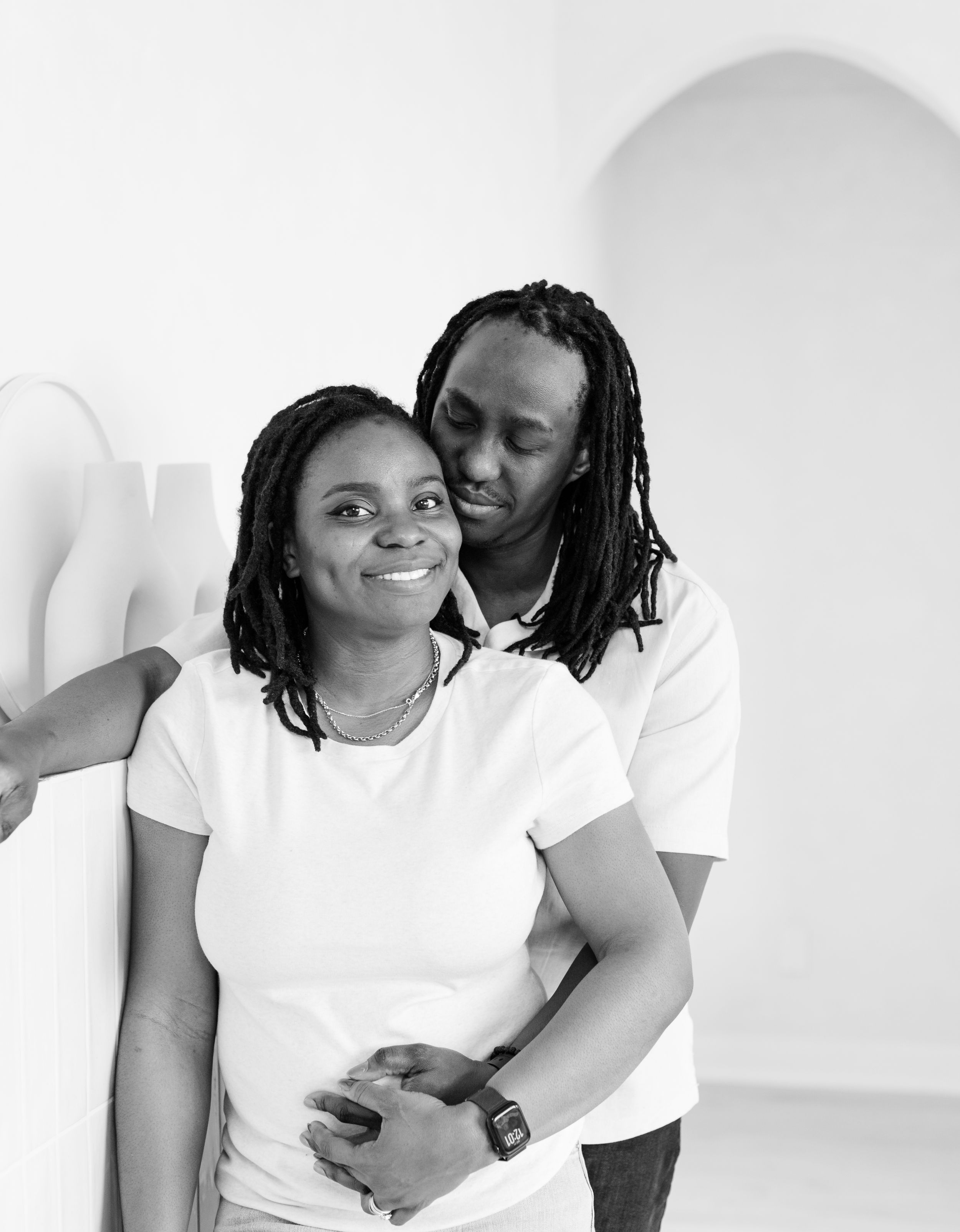Black and white photo series showing two people in white t-shirts sharing intimate moments together.