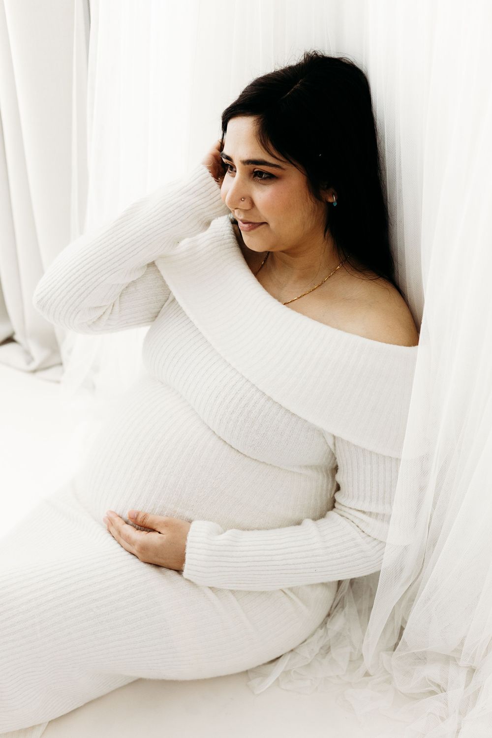 Mum-to-be smiling during her maternity photoshoot.