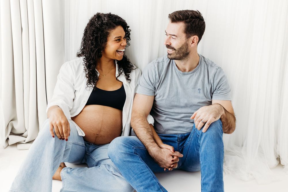 Couple holding baby bump during maternity session.