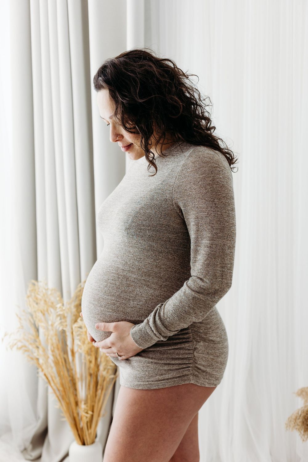 Mother-to-be in soft neutral fabrics.