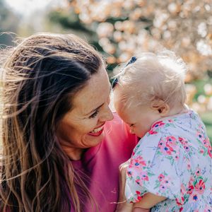 A joyful outdoor portrait session with floral patterns and warm sunlight.