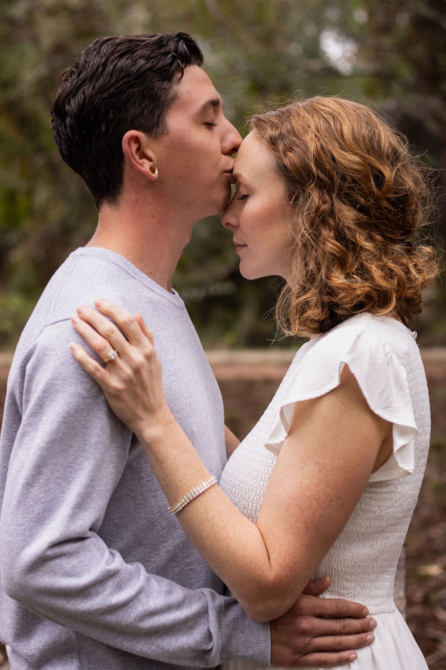 A romantic couple sharing an intimate moment outdoors.