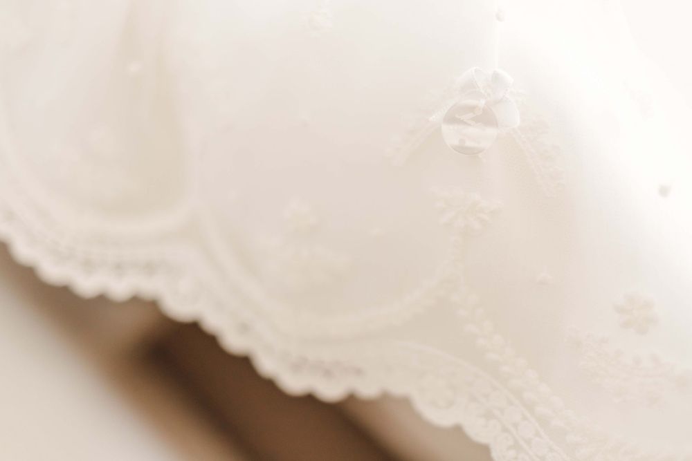 Soft focus close-up of delicate white lace fabric texture.