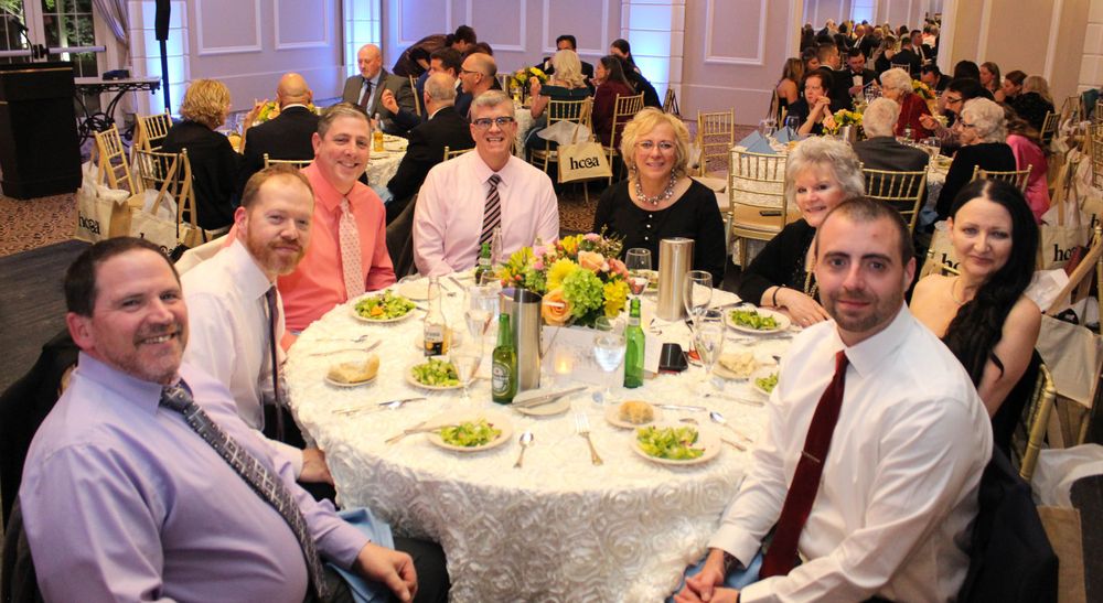 Guests seated at a round dining table during an elegant banquet or celebration.
