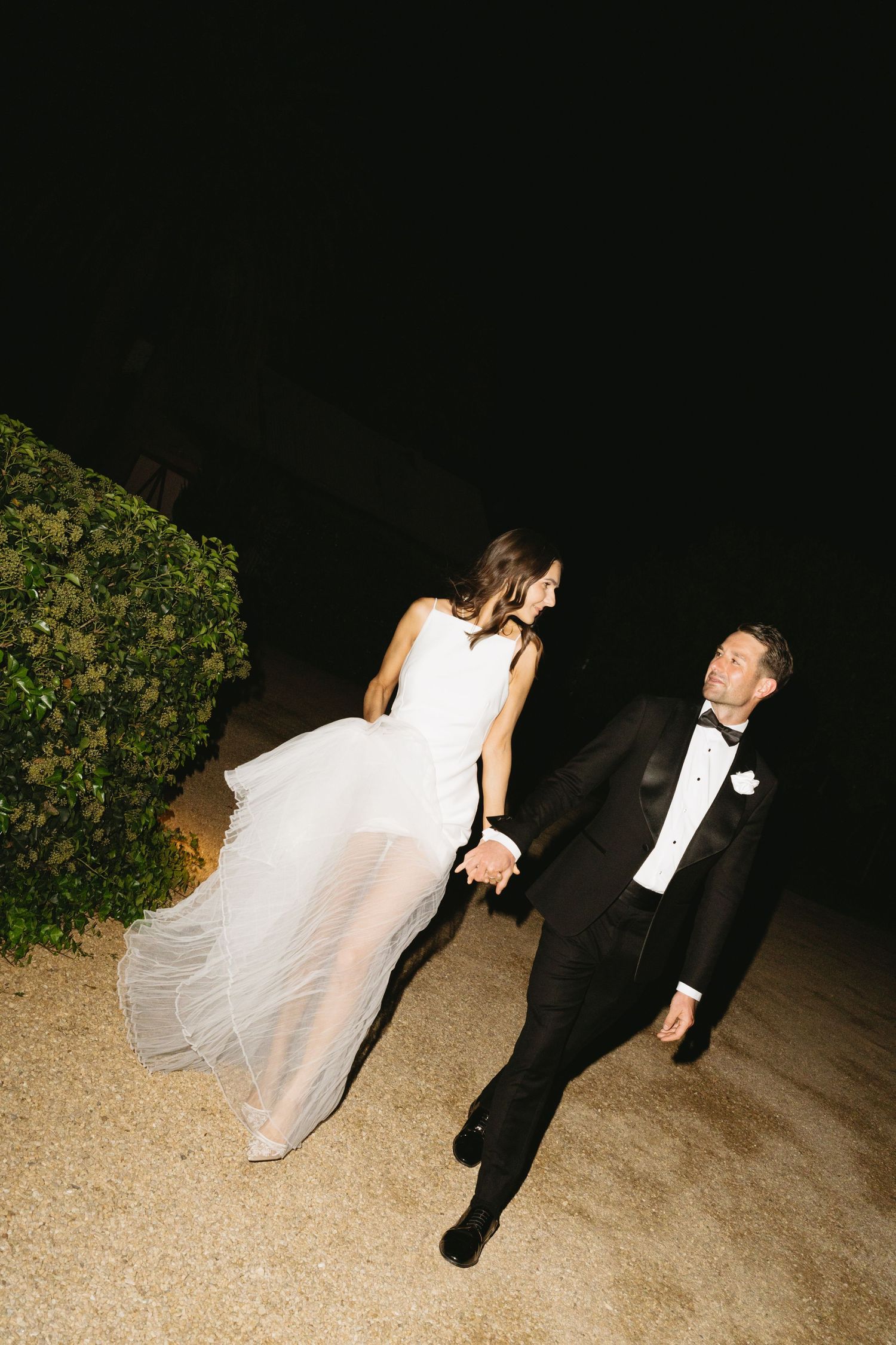 A couple in wedding attire share intimate moments during their outdoor photo session.