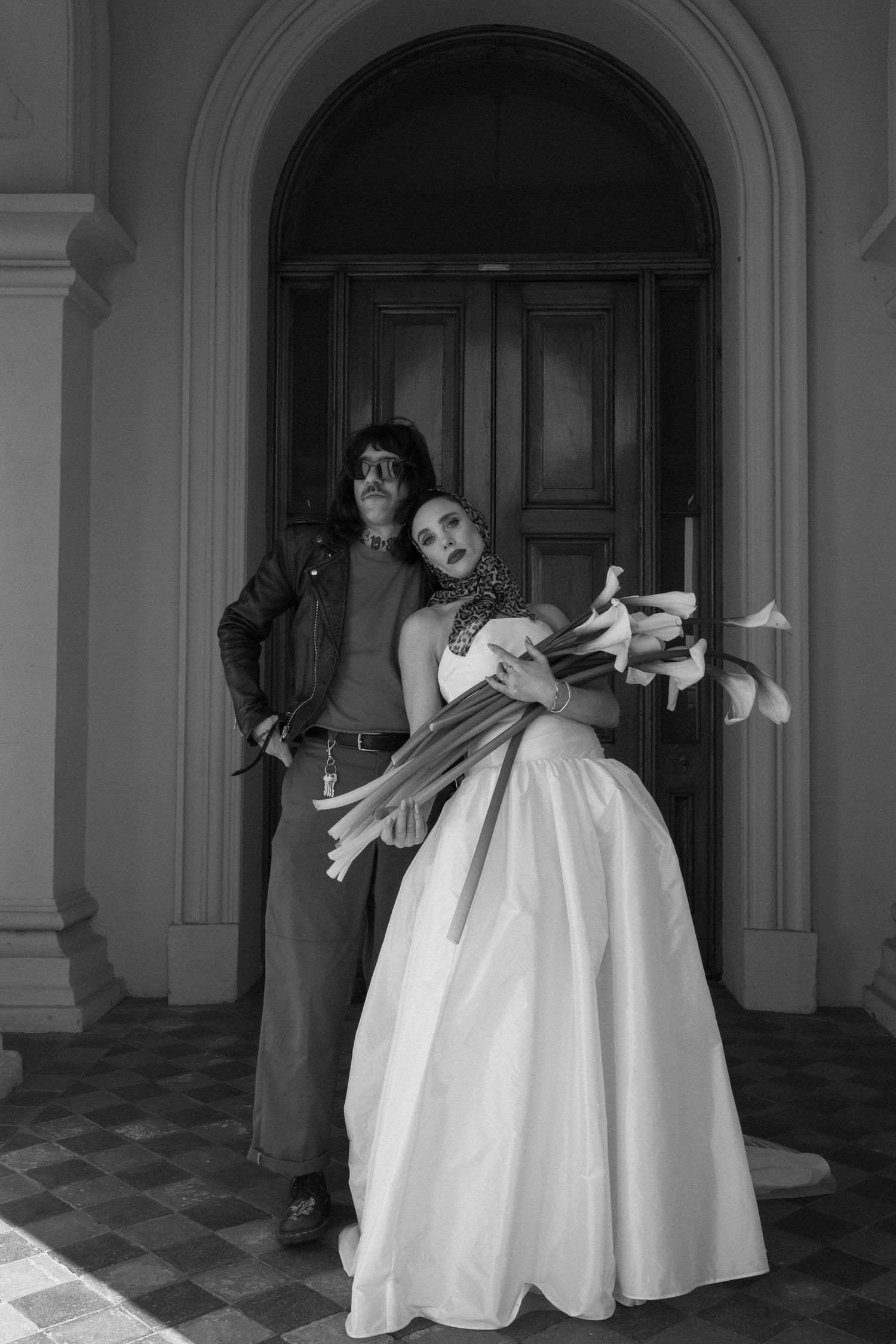 A couple in wedding attire share intimate moments during their outdoor photo session.