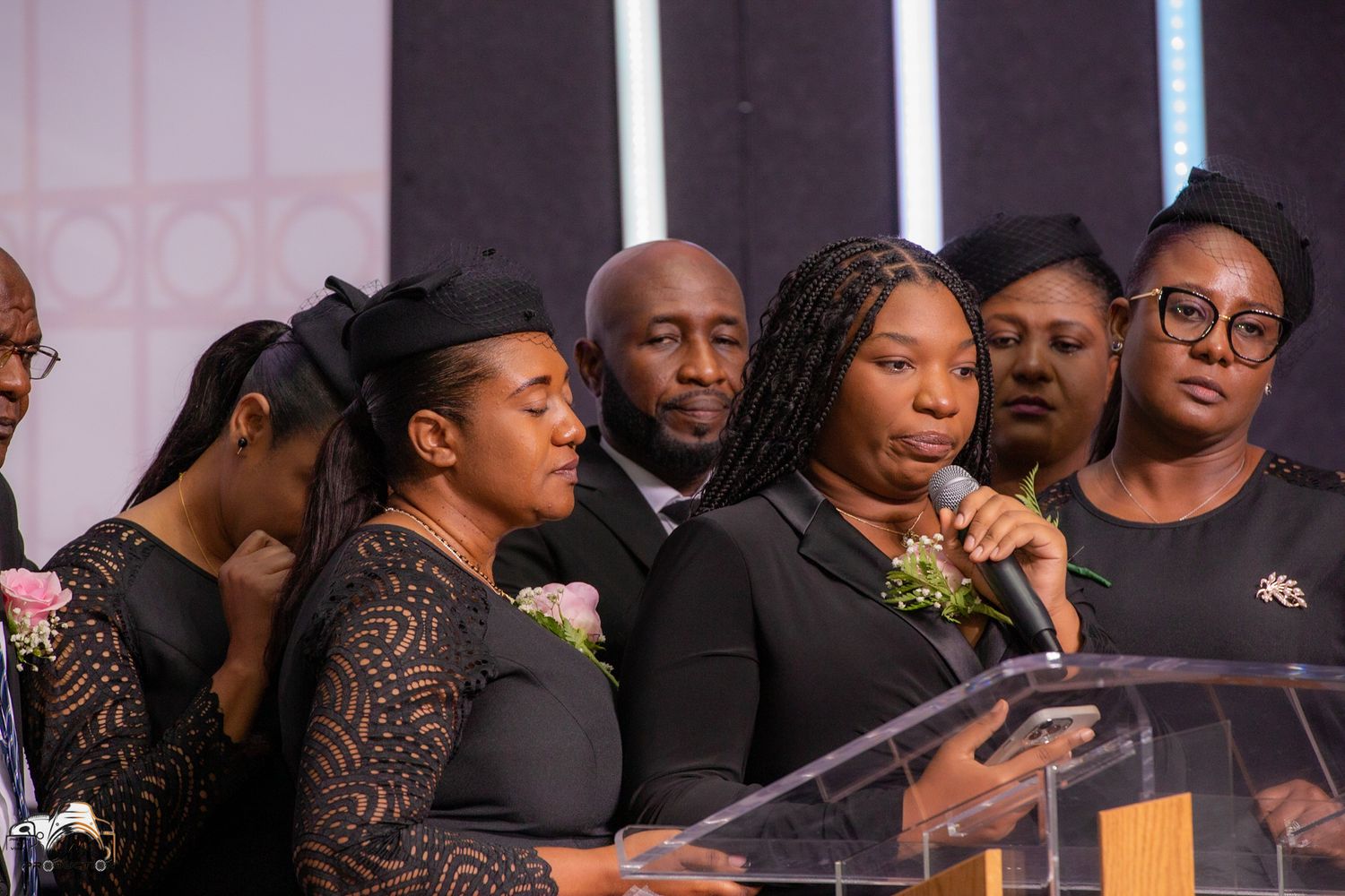 A group of people standing at a podium during a speaking engagement.